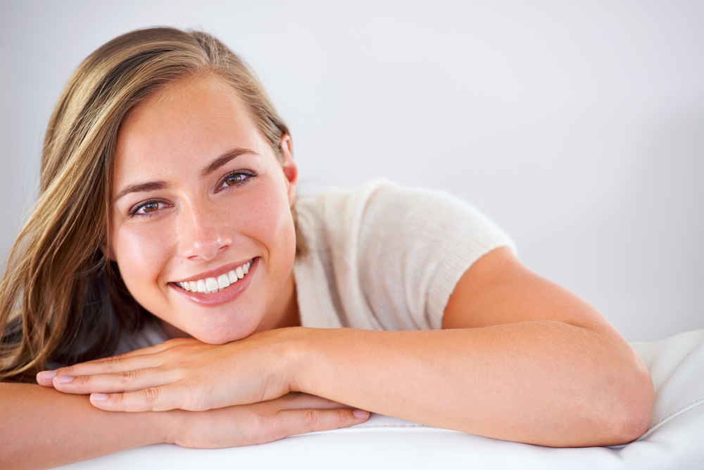 Woman with healthy smile after gum treatment in Royal Oak, MI