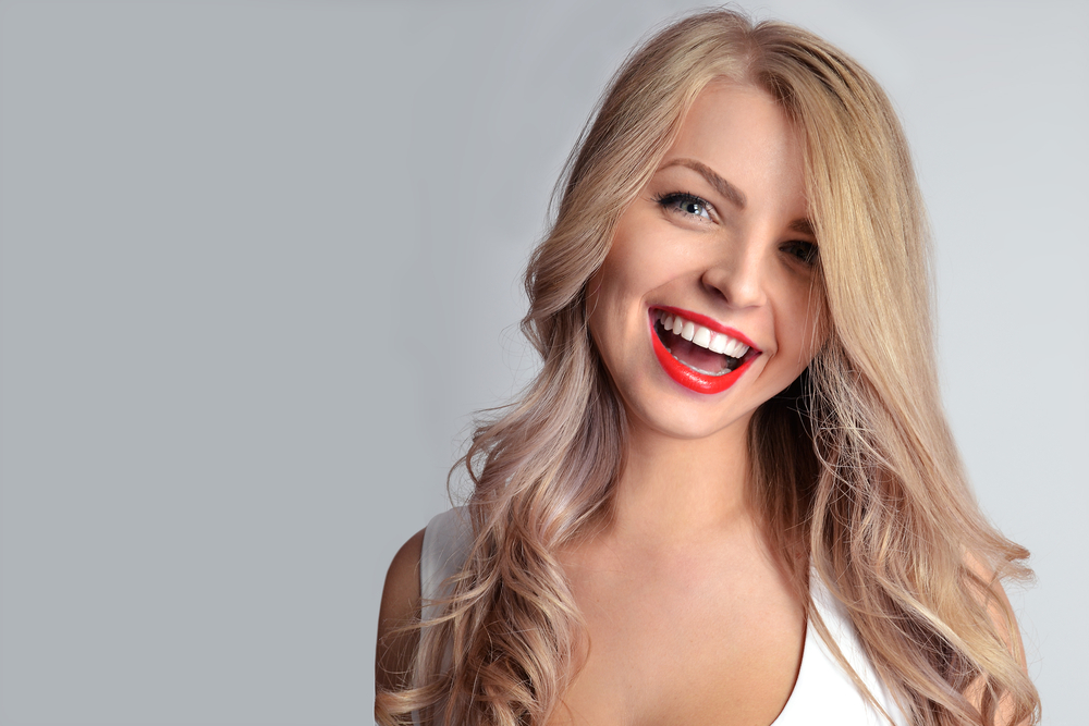 Woman with great smile after porcelain veneers in Royal Oak, MI