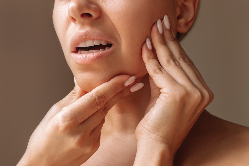 Woman experiencing TMJ pain in Royal Oak, MI
